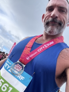 Christian from The Body Project finishing the City2Surf in 1:16:21 despite rainy conditions