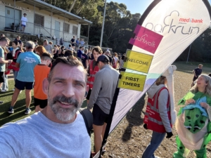Volunteers and runners gathering at the Artarmon Parkrun finish line