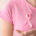 "Person wearing a pink breast cancer awareness ribbon representing recovery and rehabilitation after breast cancer treatment.