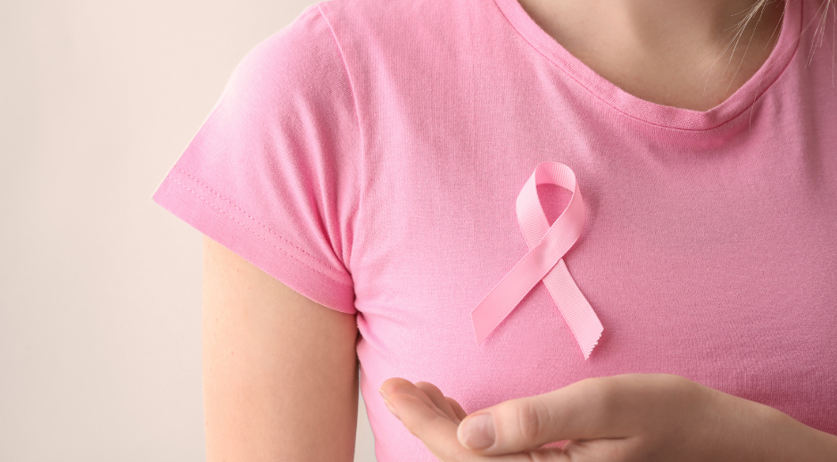 Supporting Recovery After Breast Cancer Treatment "Person wearing a pink breast cancer awareness ribbon representing recovery and rehabilitation after breast cancer treatment.